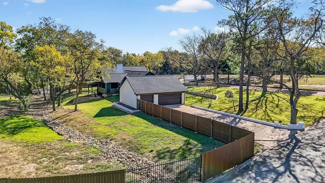 a aerial view of a residential houses with yard