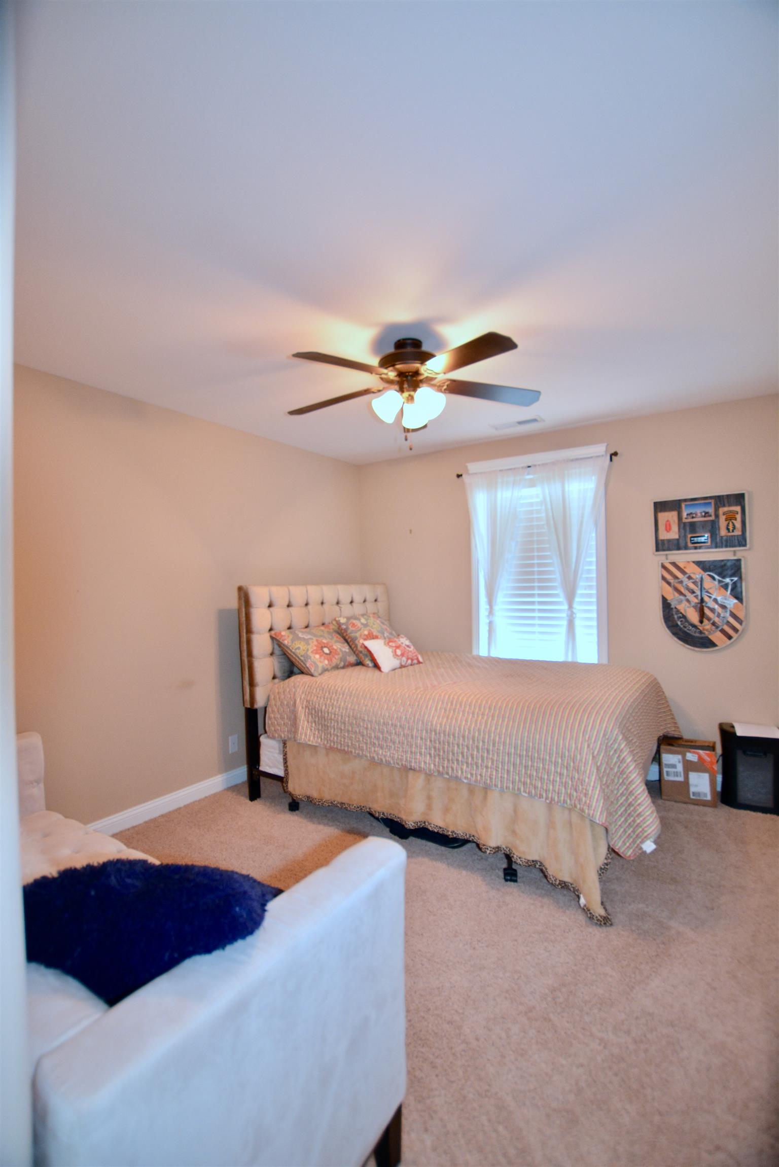 3778 Suiter Road Clarksville, TN 37040 - Photo 14 of 16 a bedroom with a bed and a chandelier