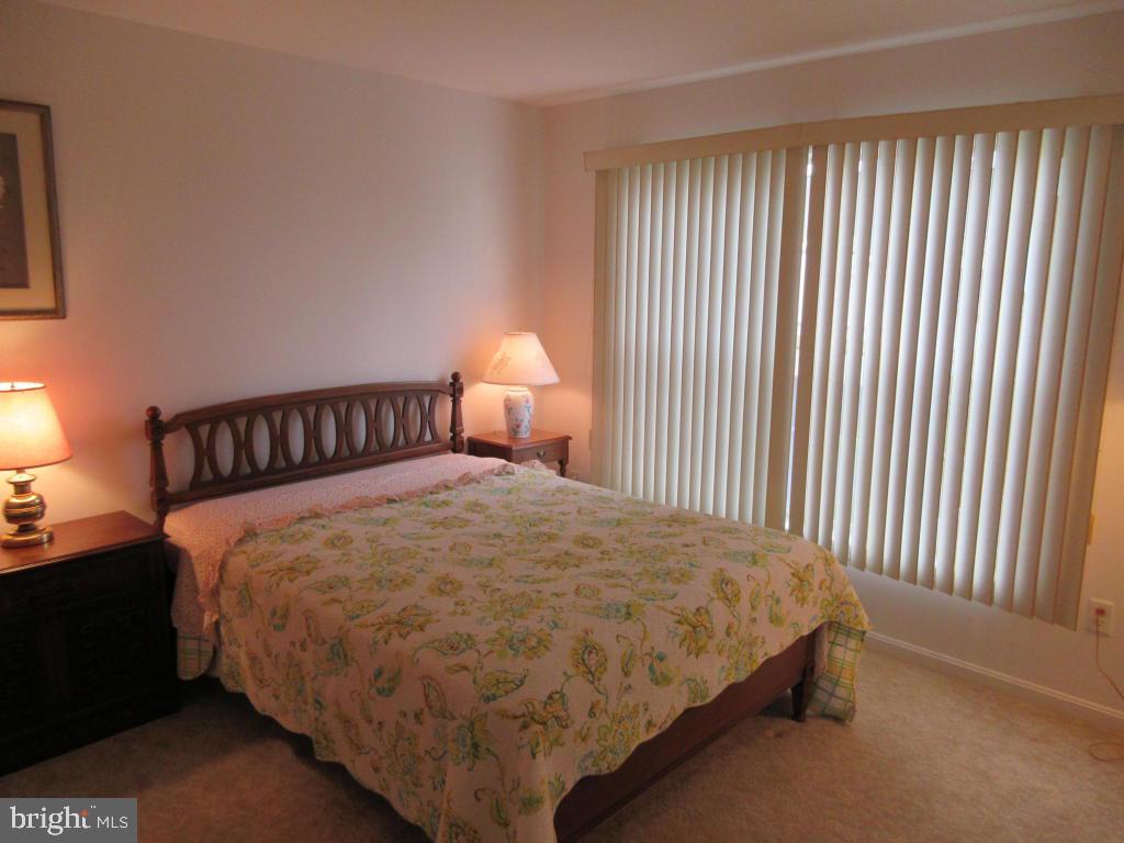 629 Chatham Way Lititz, PA 17543 - Photo 14 of 18 a bed sitting in a bedroom next to a lamp
