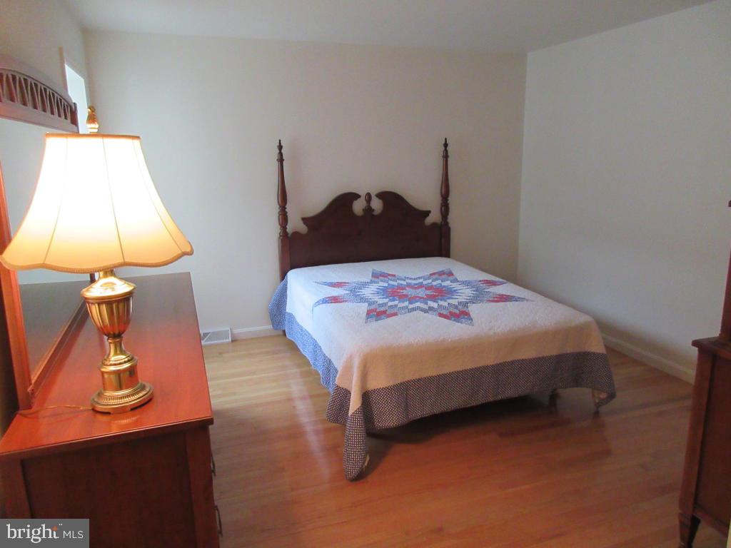 629 Chatham Way Lititz, PA 17543 - Photo 9 of 18 a bedroom with a bed and a lamp