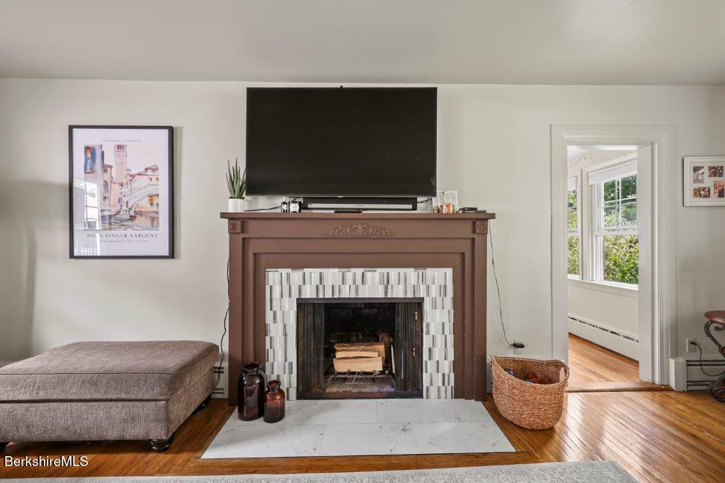 33 Eleanor Road Pittsfield, MA 01201 - Photo 9 of 45 a living room with furniture a flat screen tv and a fireplace