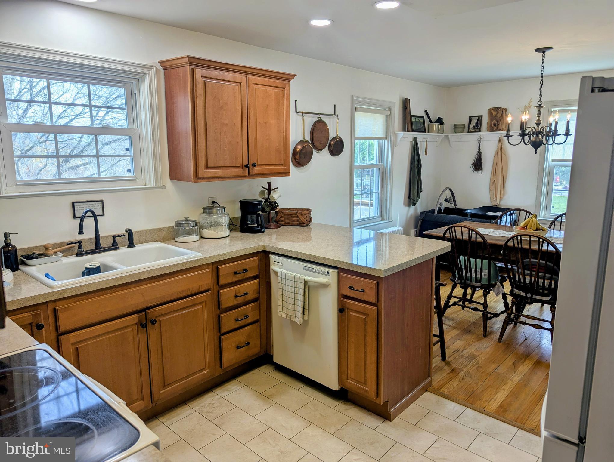 3 Locust Lane Womelsdorf, PA 19567 - Photo 13 of 37 a kitchen with a stove top oven a sink dishwasher and a refrigerator with wooden cabinets