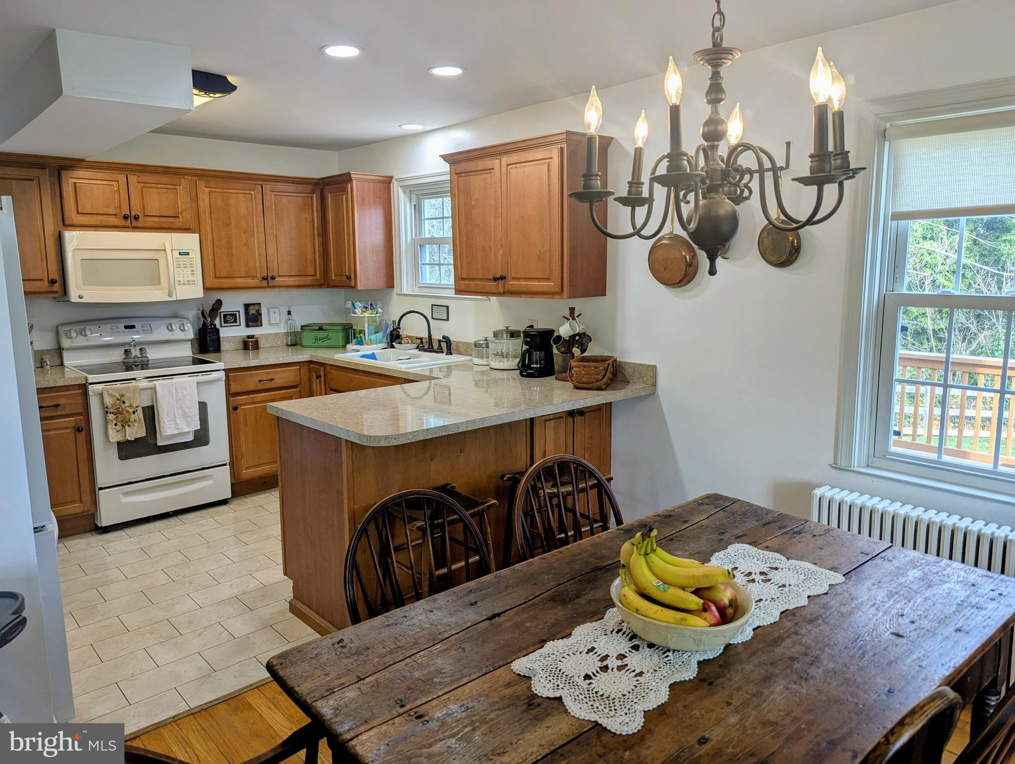 3 Locust Lane Womelsdorf, PA 19567 - Photo 10 of 37 a kitchen with stainless steel appliances granite countertop a sink a stove a table and chairs