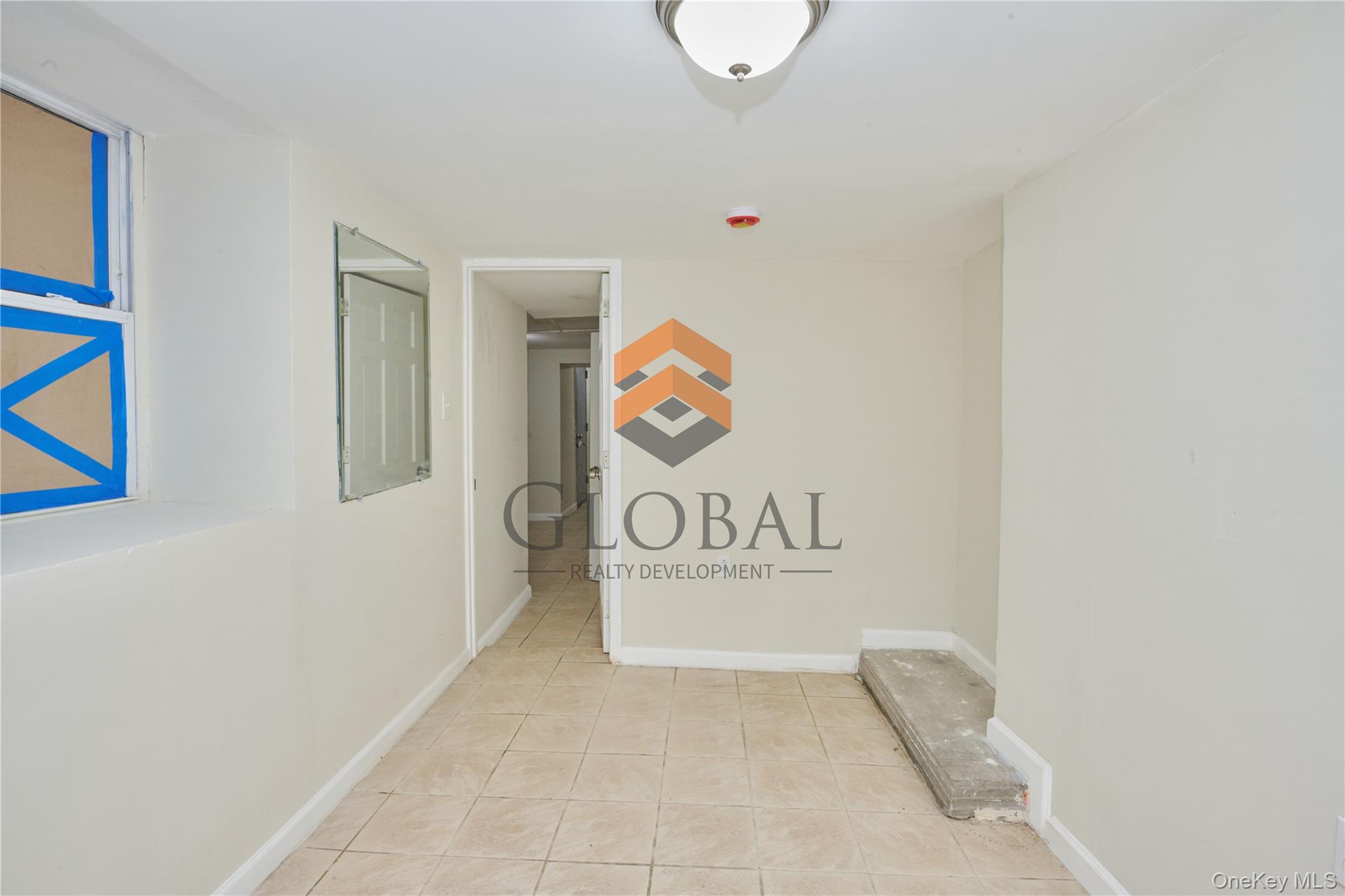 680 Union Avenue Bronx, NY 10455 - Photo 11 of 15 Corridor featuring baseboards and light tile patterned floors