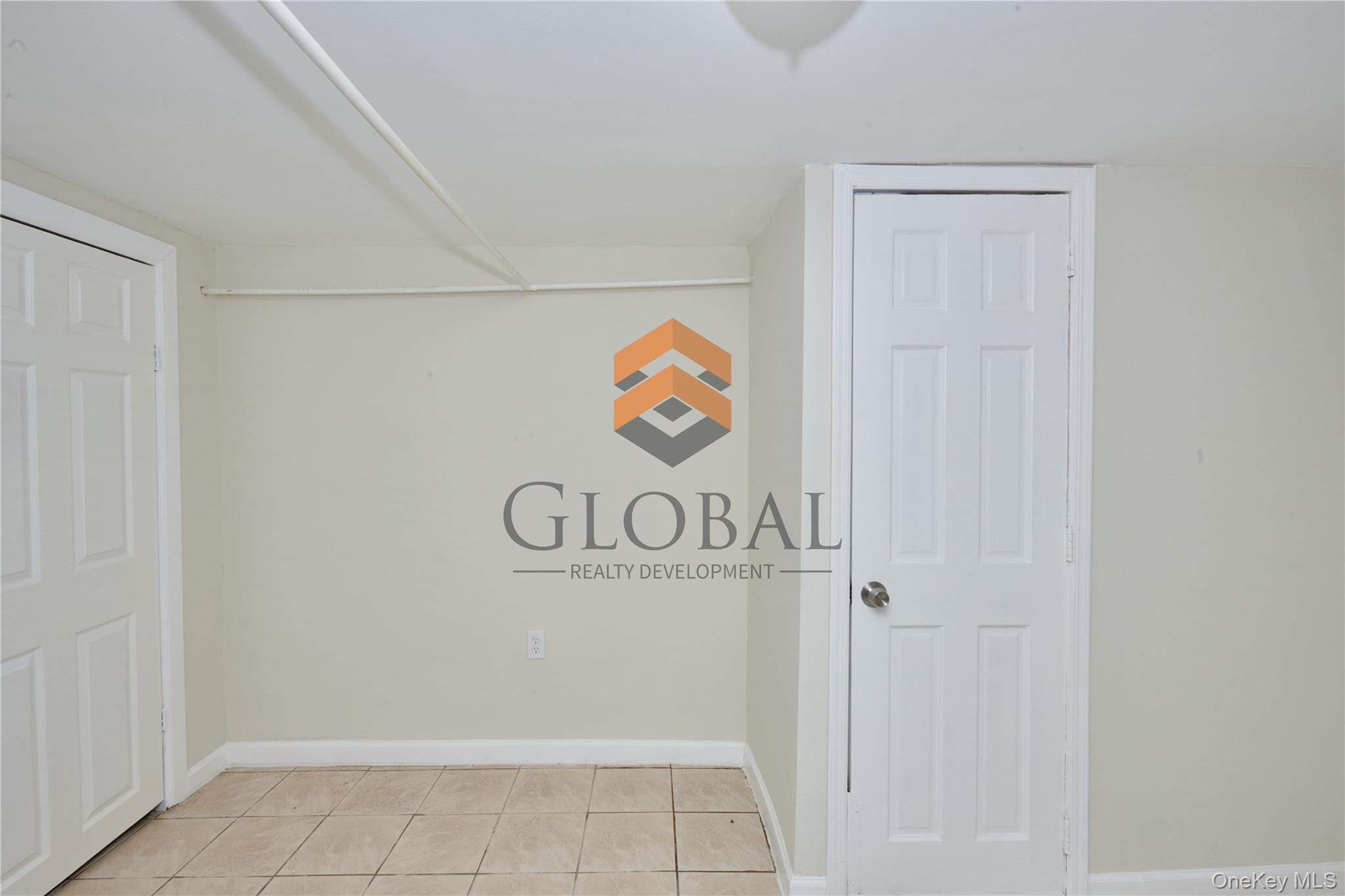 680 Union Avenue Bronx, NY 10455 - Photo 6 of 15 Unfurnished bedroom with baseboards and light tile patterned floors