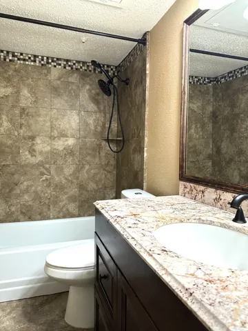 an empty room with a ceiling fan and window