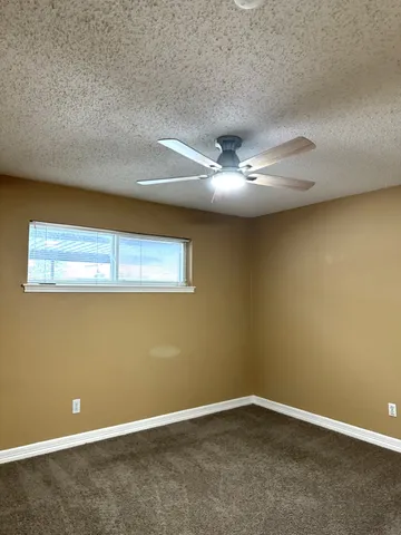 a bathroom with a granite countertop sink mirror vanity and toilet
