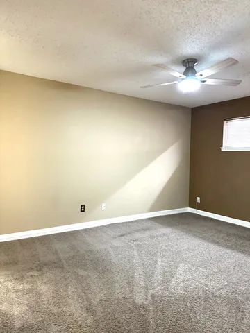 a bathroom with a granite countertop sink mirror vanity and toilet
