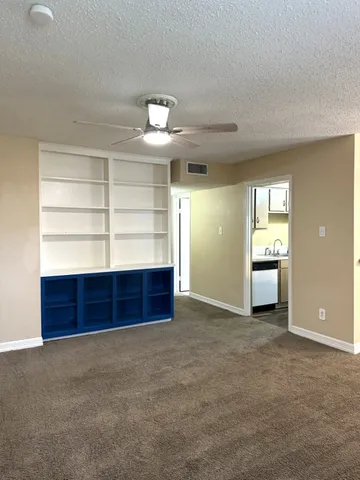 a view of a room with a fireplace and window