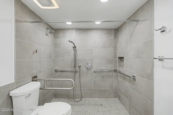 a bathroom with a toilet and shower