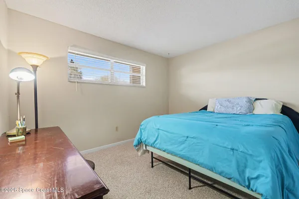 a bedroom with a bed and a mirror