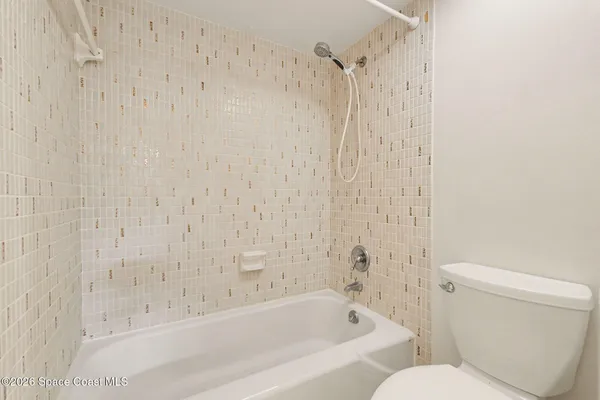 a bathroom with a bathtub and a toilet