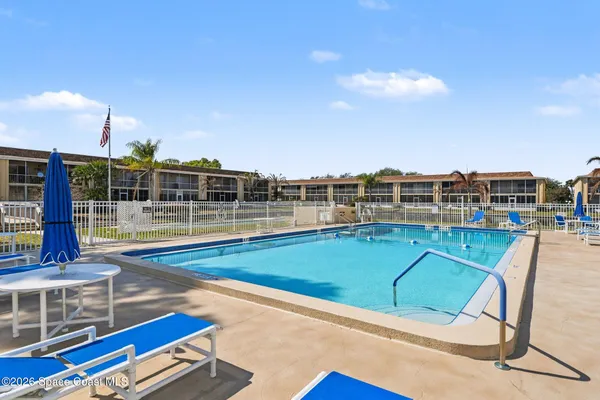 a view of a swimming pool with seating space