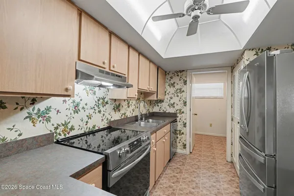 a kitchen with stainless steel appliances granite countertop a stove and a refrigerator
