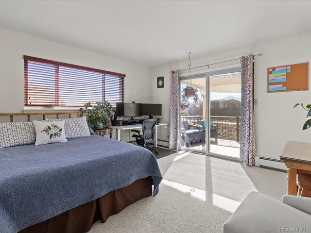 a bedroom with a large bed and a large window