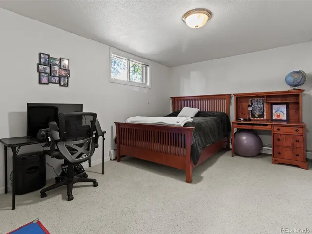 a bedroom with a bed and a chair