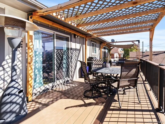a view of a patio with table and chairs