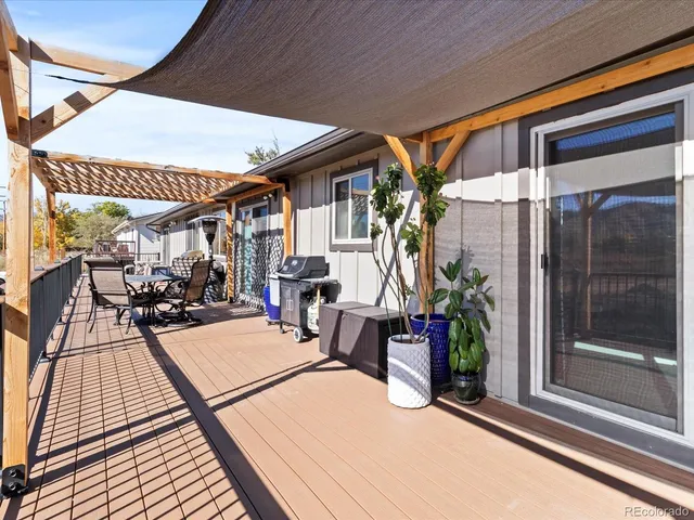 a view of a patio with table and chairs potted plants with wooden floor