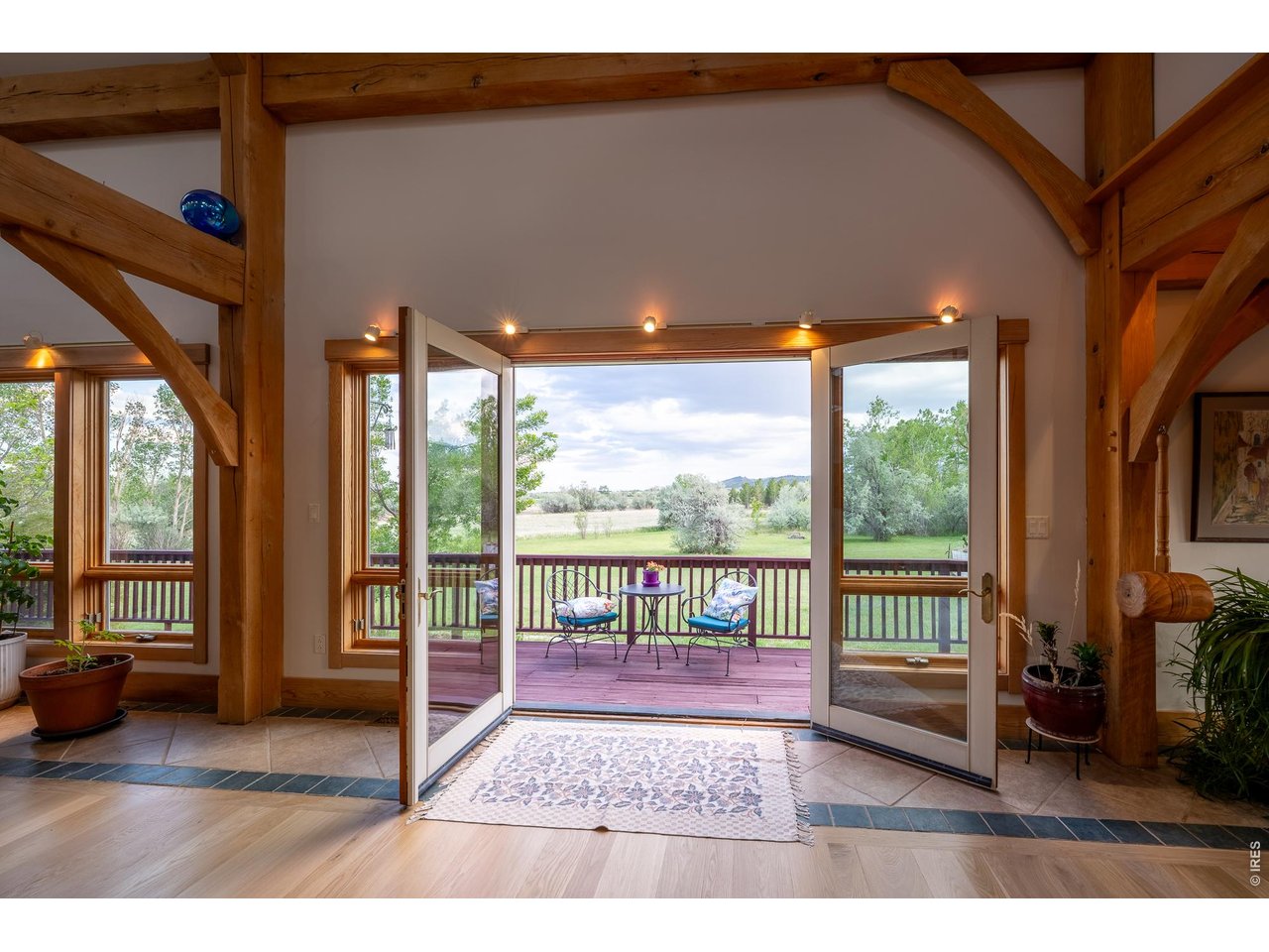 4099 Michaud Lane Fort Collins, CO 80521 - Photo 27 of 50 Oversized French doors welcome the outdoors in, creating a bright and airy connection between the comfort of home and the natural beauty beyond.