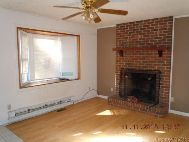 310 Howell Road, Unit 2 Canton, NC 28716 - Photo 3 of 5 a view of an empty room with a fireplace
