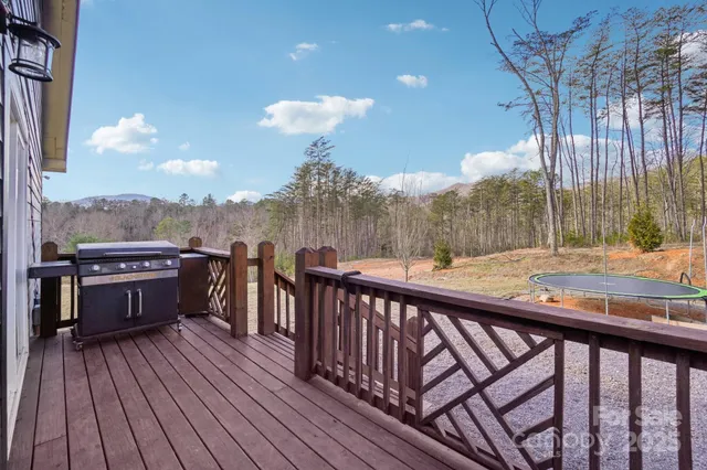 a view of a balcony with wooden floor and fence