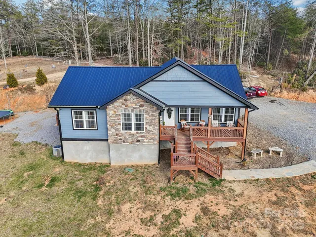 a wooden bench sitting in the middle of a yard