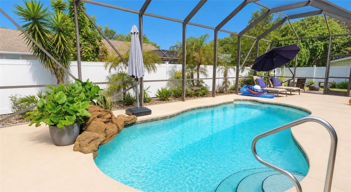 1771 Mistletoe Street Sebastian, FL 32958 - Photo 29 of 36 a view of a swimming pool with a chairs in patio