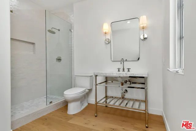 a bathroom with a toilet sink and shower
