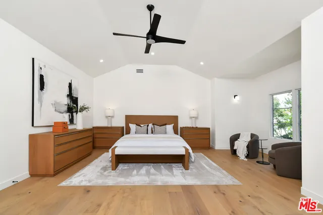 a spacious bedroom with a bed and a couch