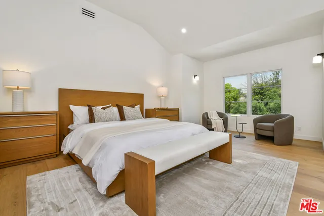 a bedroom with a bed and a couch