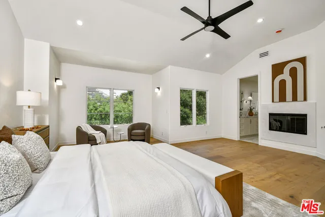 a bedroom with a large bed and a large window