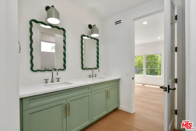 a bathroom with 2 sink and a mirror
