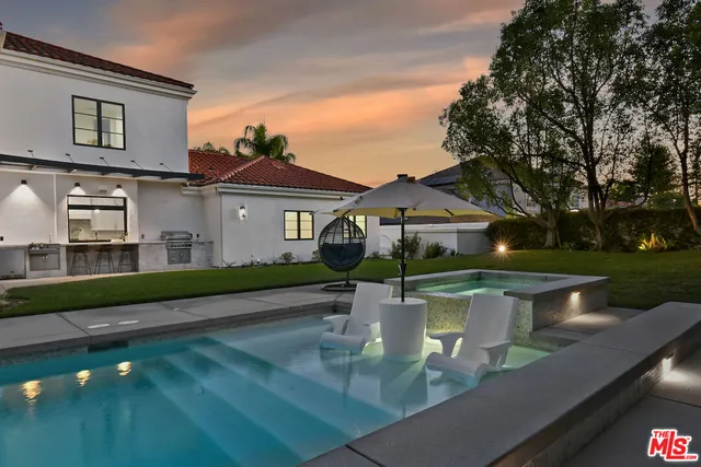 a front view of a house with a garden and plants