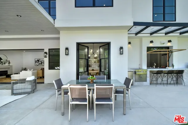 a view of a house with backyard porch and sitting area