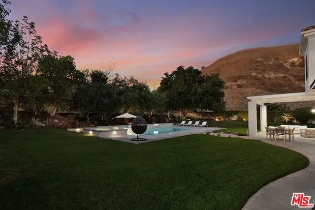 a front view of house with yard and swimming pool