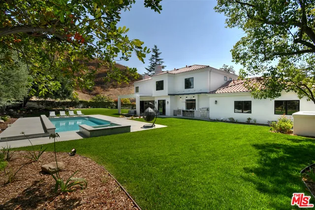 a view of a swimming pool with a yard