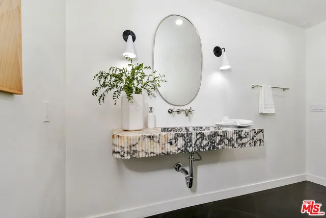 a bathroom with a sink and mirror
