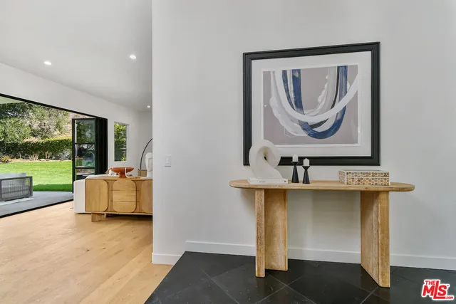 a living room with furniture and a floor to ceiling window