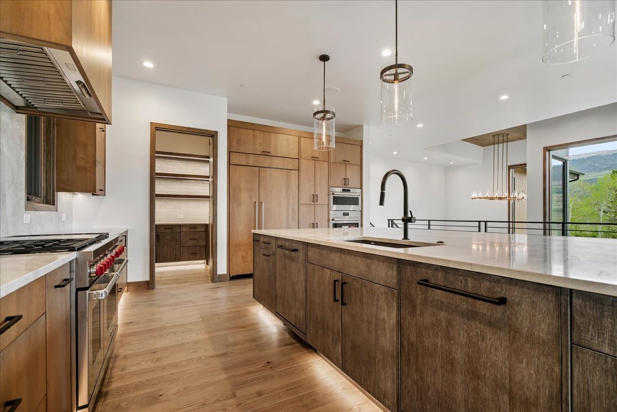 1615 Golden Eagle Road Silverthorne, CO 80498 - Photo 9 of 47 a kitchen with counter top space sink stove and refrigerator