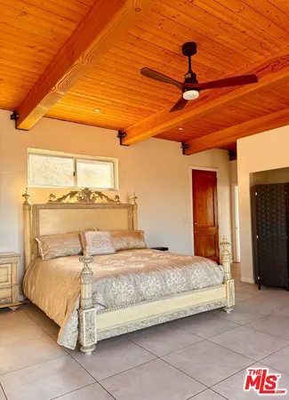 a bedroom with a bed and a night stand