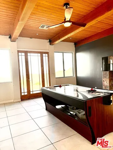 a room with granite countertop furniture a flat screen tv and next to a window