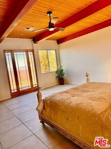 a bed sitting in a bedroom next to a window