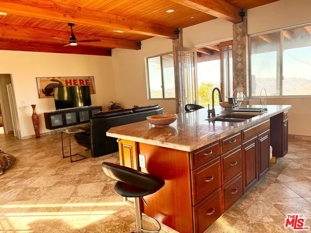 a kitchen with stainless steel appliances granite countertop a stove a sink and a wooden cabinets