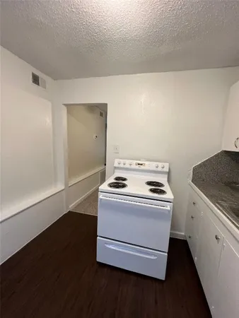 a stove top oven sitting inside of a kitchen