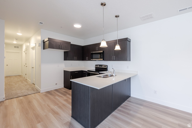 675 West 4500th South, Unit P201 Mapleton, UT 84664 - Photo 12 of 16 Modern kitchen featuring dark wood-finish cabinetry, light countertops, and stainless steel appliances