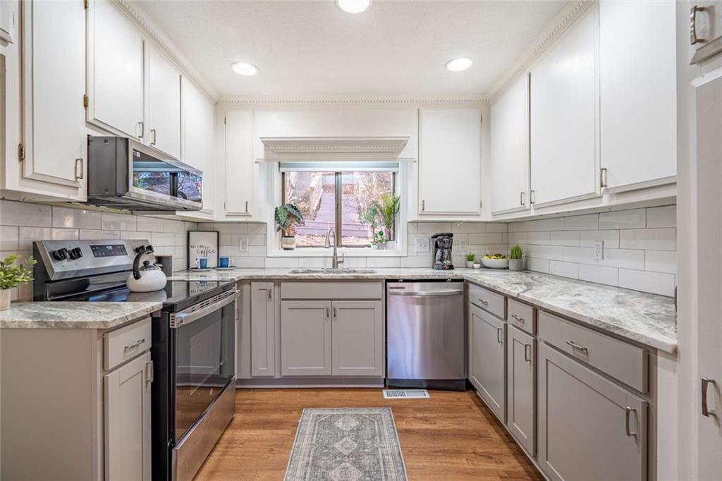 200 Villa Road, Unit 126 Jasper, GA 30143 - Photo 20 of 38 a kitchen with stainless steel appliances granite countertop a sink stove cabinets and a granite counter tops