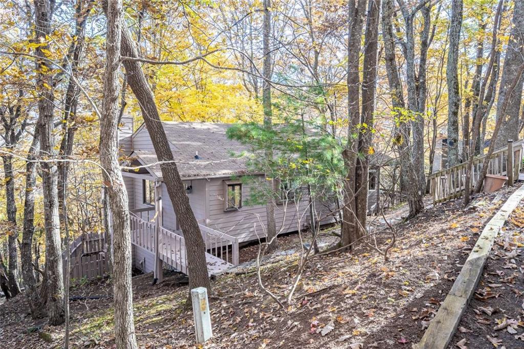 200 Villa Road, Unit 126 Jasper, GA 30143 - Photo 2 of 38 a view of a house with a tree next to a yard