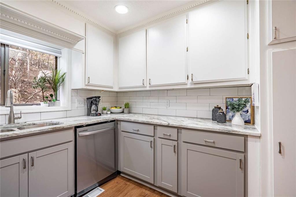 200 Villa Road, Unit 126 Jasper, GA 30143 - Photo 24 of 38 a kitchen with white cabinets and white appliances