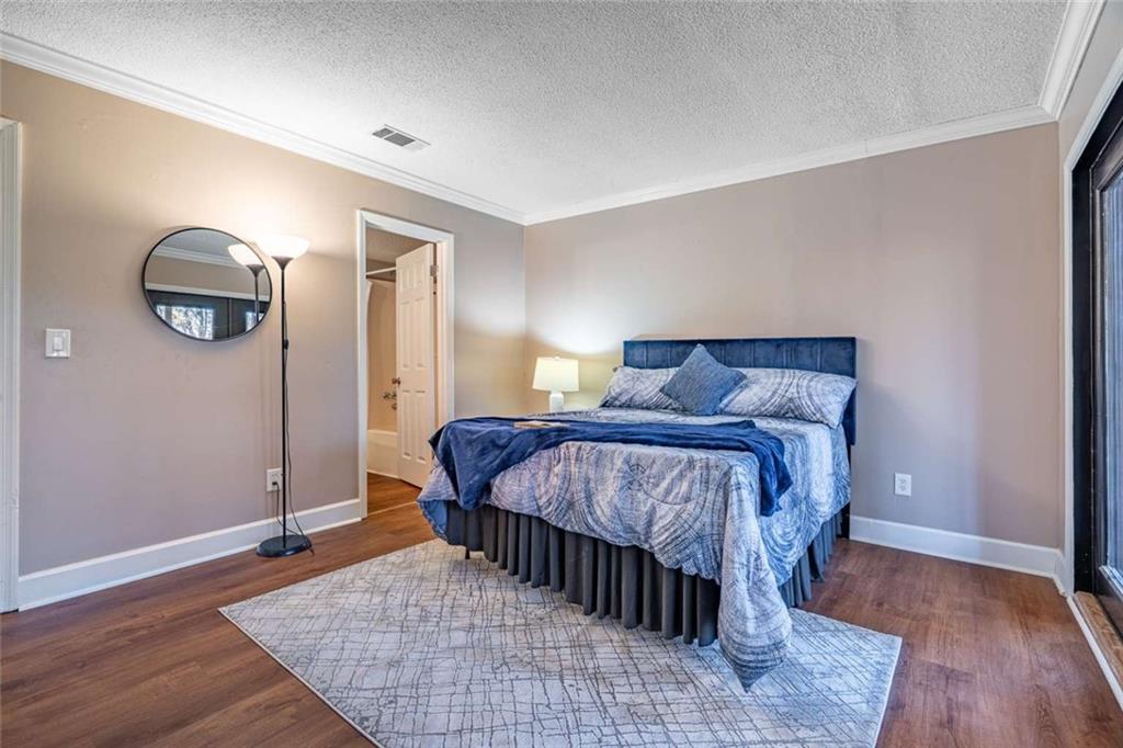 200 Villa Road, Unit 126 Jasper, GA 30143 - Photo 29 of 38 a bedroom with a bed and wooden floor