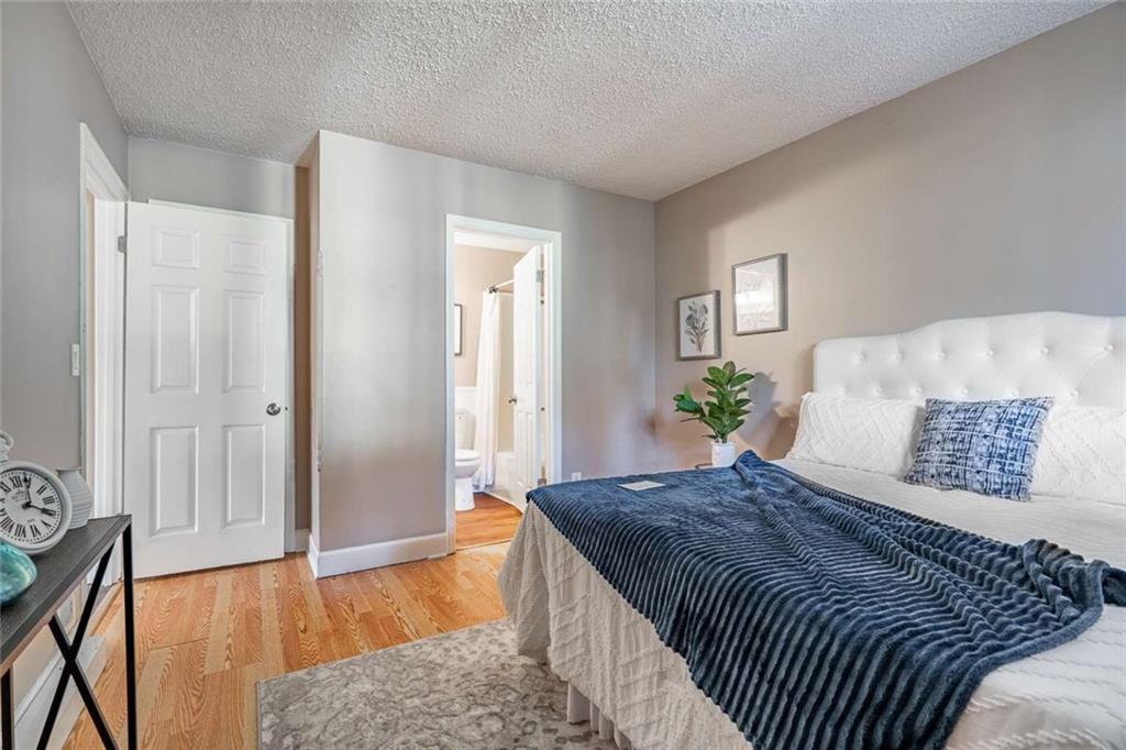 200 Villa Road, Unit 126 Jasper, GA 30143 - Photo 34 of 38 a bedroom with a large bed and wooden floor